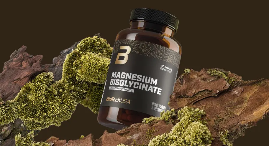 Flacon de gélules de magnésium bisglycinate posé à côté d'un verre d'eau